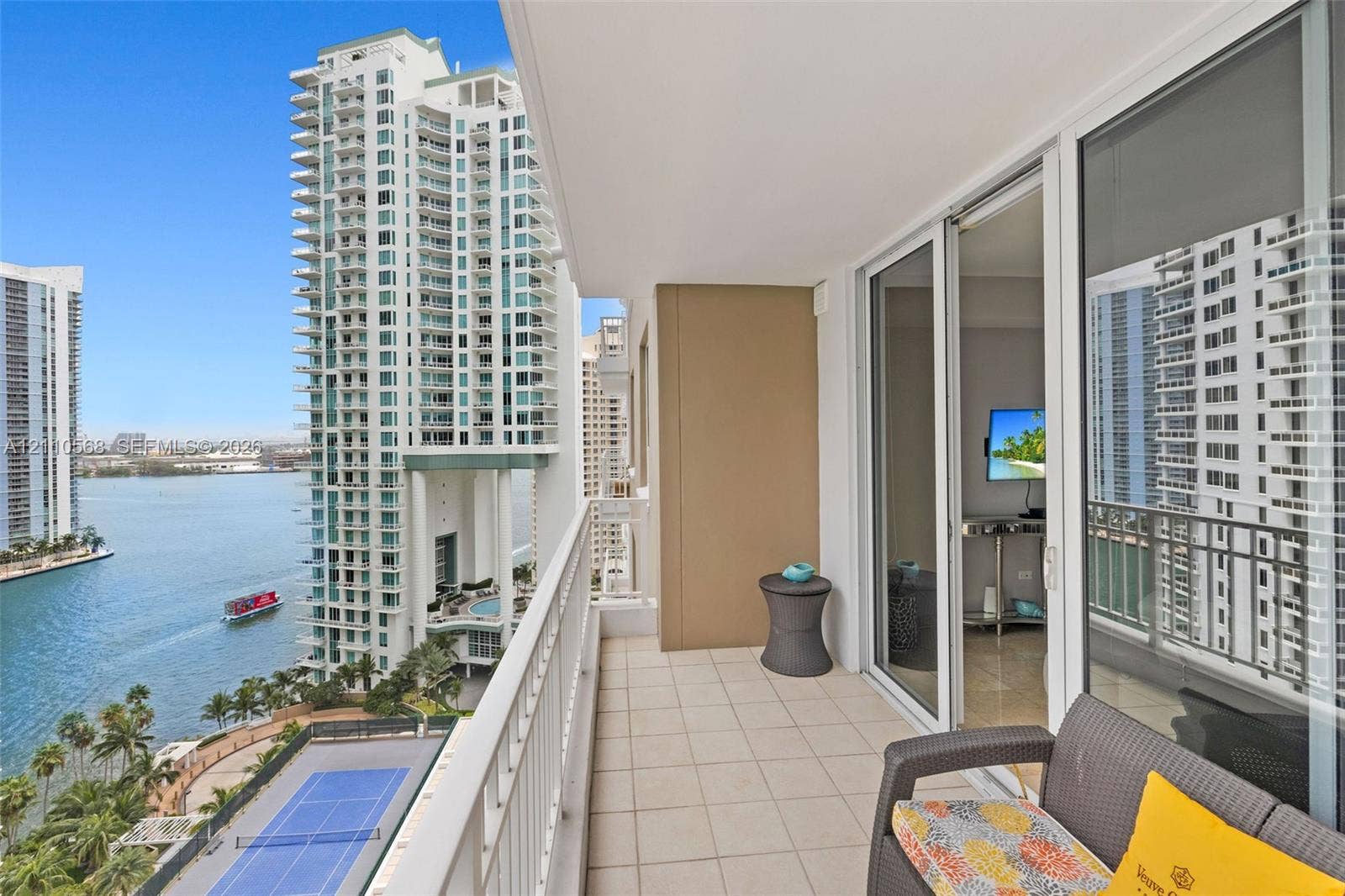 801 Brickell Key Boulevard, #2006, Miami, FL 33131 Private balcony featuring tile flooring and a metal railing, overlooking the water and tennis courts