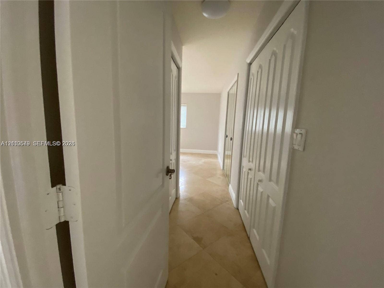 232 NE 12th Avenue, #301, Hallandale Beach, FL 33009 Hallway featuring diagonal tile flooring, multi-panel doors, and built-in closet cabinetry