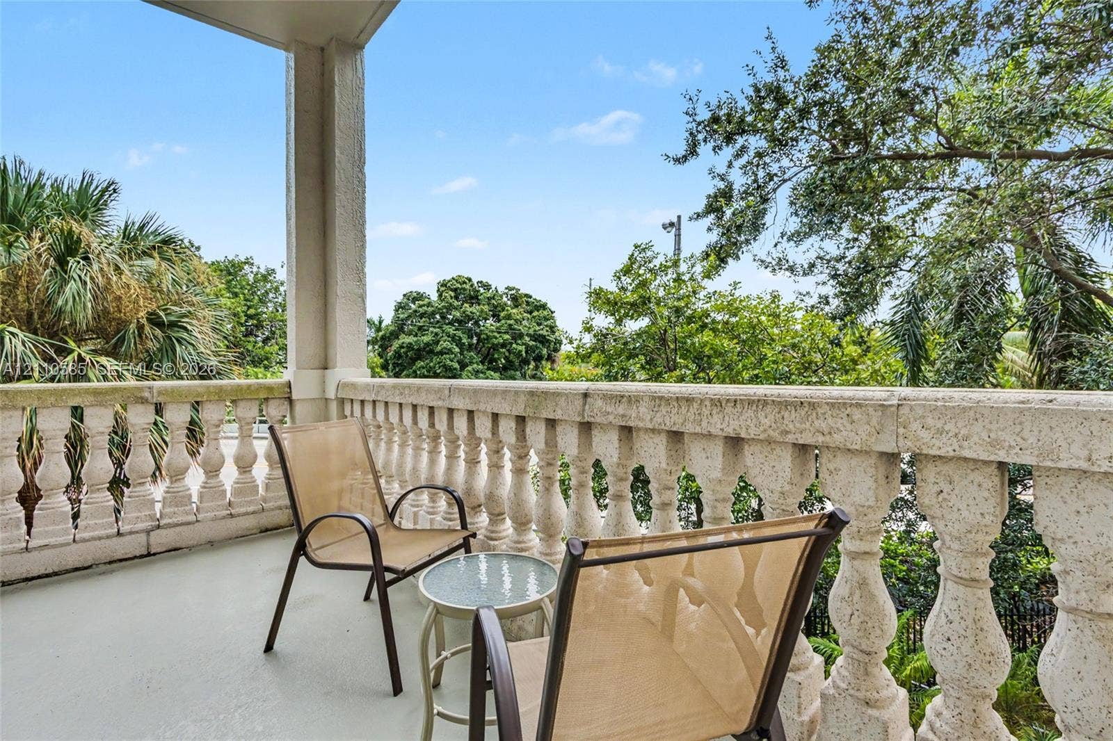 600 W Las Olas Boulevard, #202S, Fort Lauderdale, FL 33312 Covered balcony featuring a textured stone-finish balustrade, support column, and concrete flooring