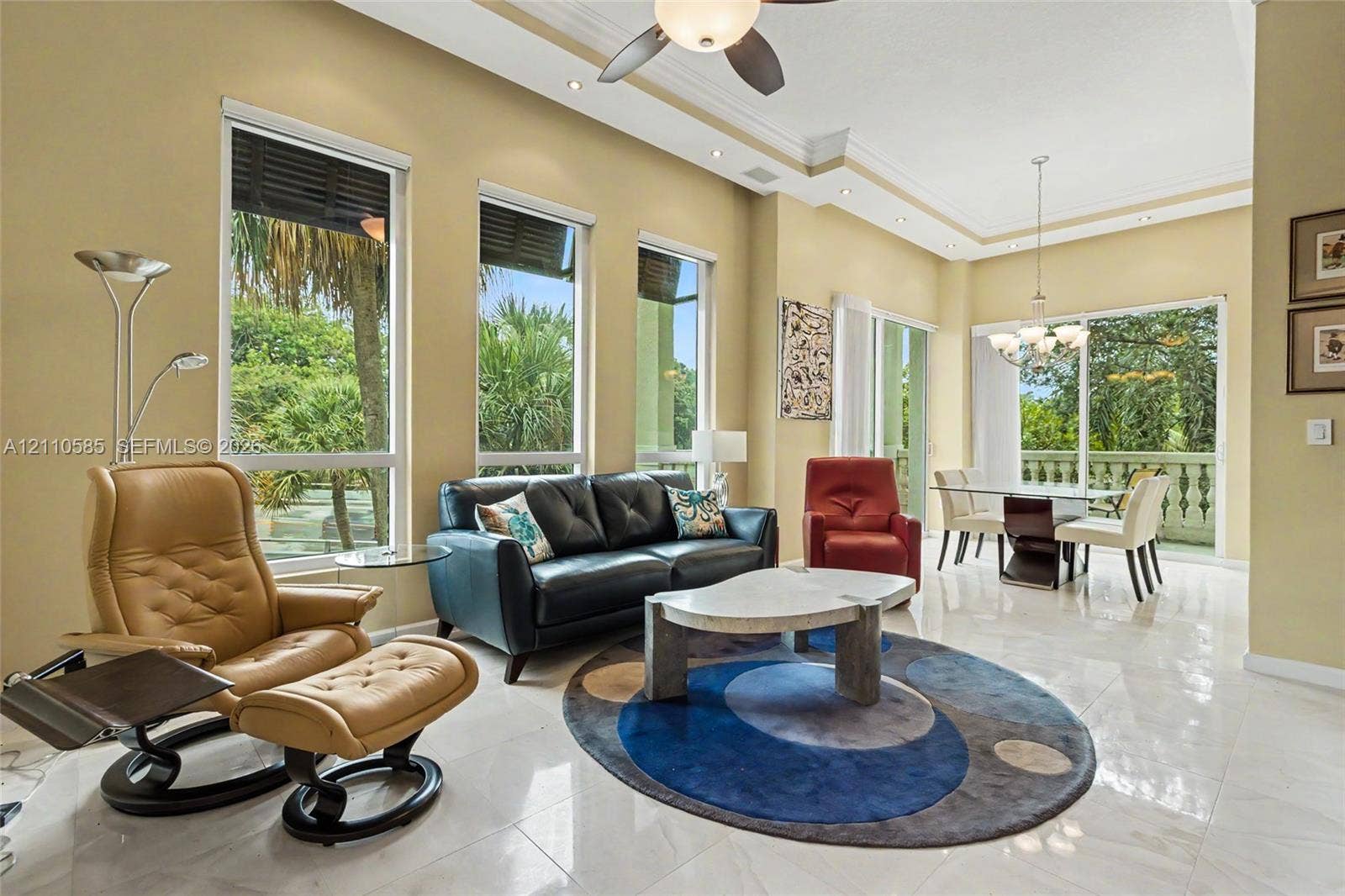 600 W Las Olas Boulevard, #202S, Fort Lauderdale, FL 33312 Open-concept living space featuring high ceilings with crown molding, large-format tile flooring, recessed lighting, and expansive windows providing natural light