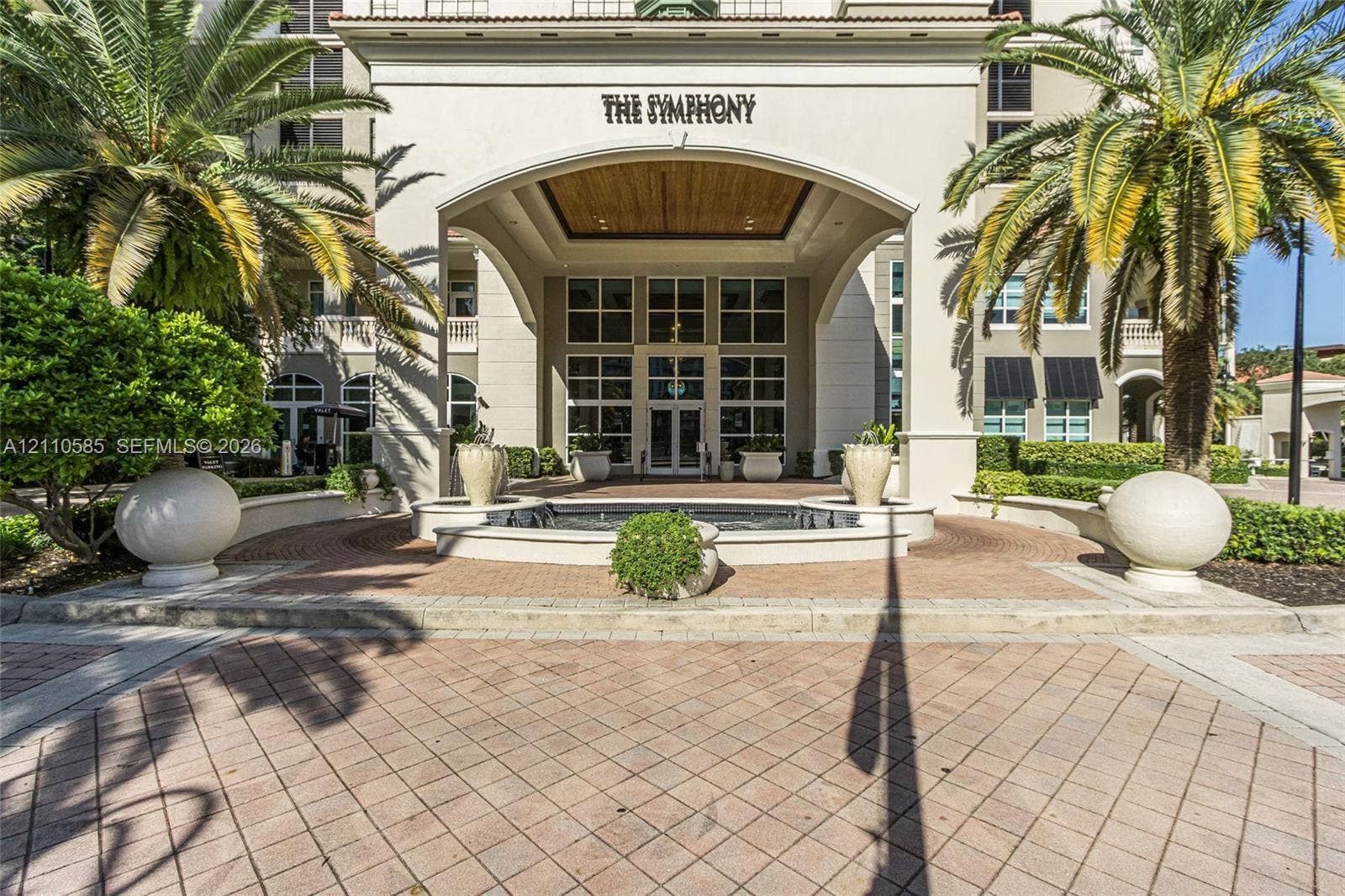 600 W Las Olas Boulevard, #202S, Fort Lauderdale, FL 33312 Covered porte-cochre entry featuring a stone-paved motor court, central water fountain, and wood-paneled ceiling detailing