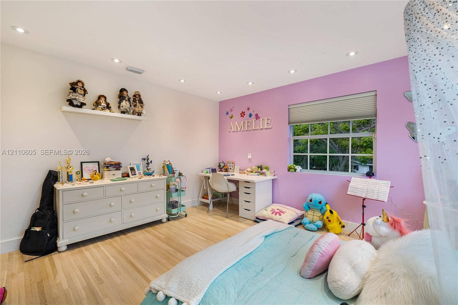Bedroom featuring wood-finish flooring, recessed lighting, and a built-in floating wall shelf
