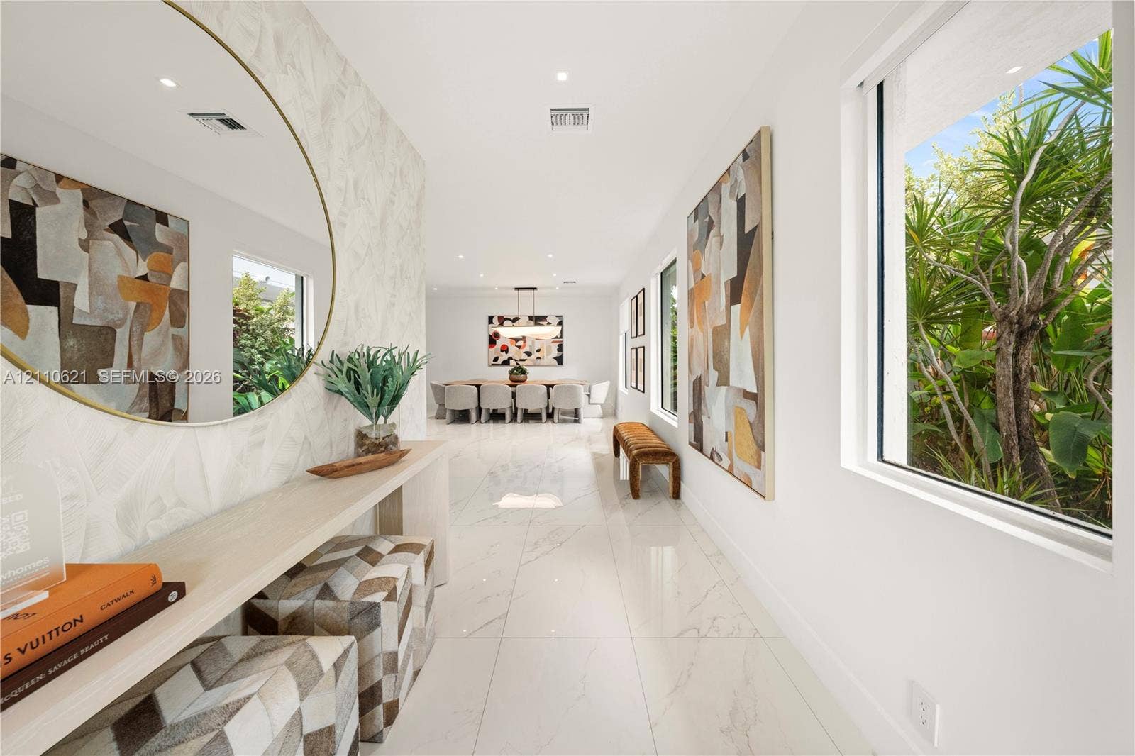 Interior featuring polished tile flooring, recessed ceiling lighting, and large-format windows with greenery exposure