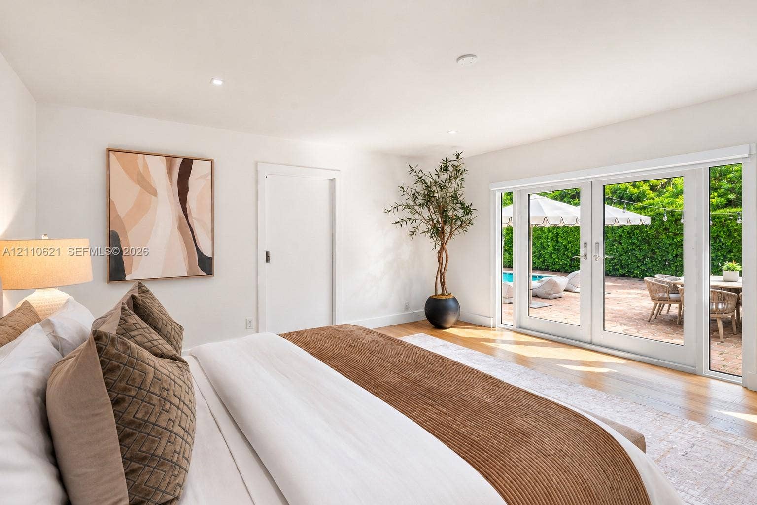 Interior featuring wood-finish flooring, recessed lighting, and double glass doors with sidelights
