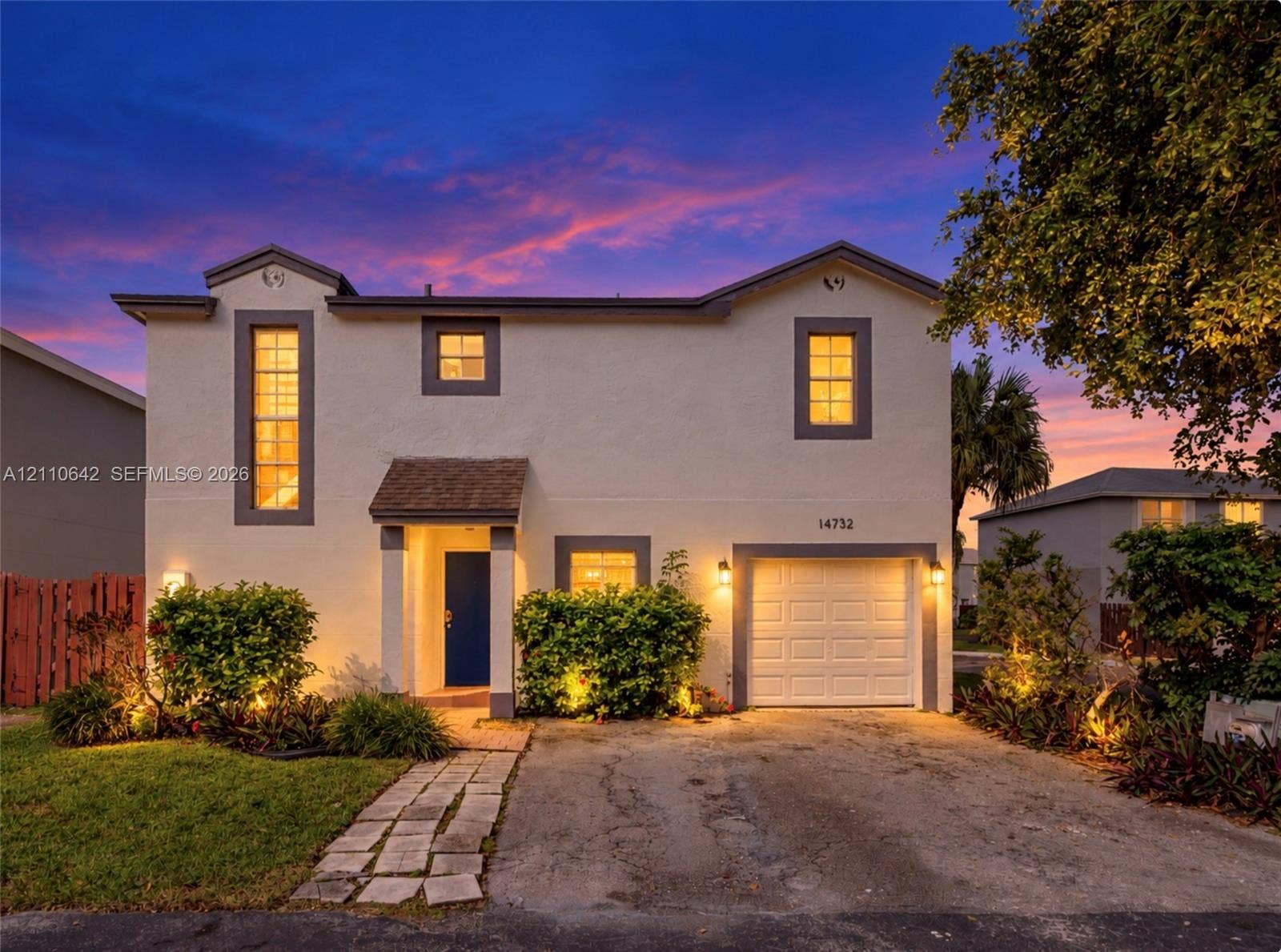 14732 SW 90th Terrace, Miami, FL 33196 Two-story exterior featuring light-toned stucco, a single-car garage, a covered entryway, and vertical accent windows