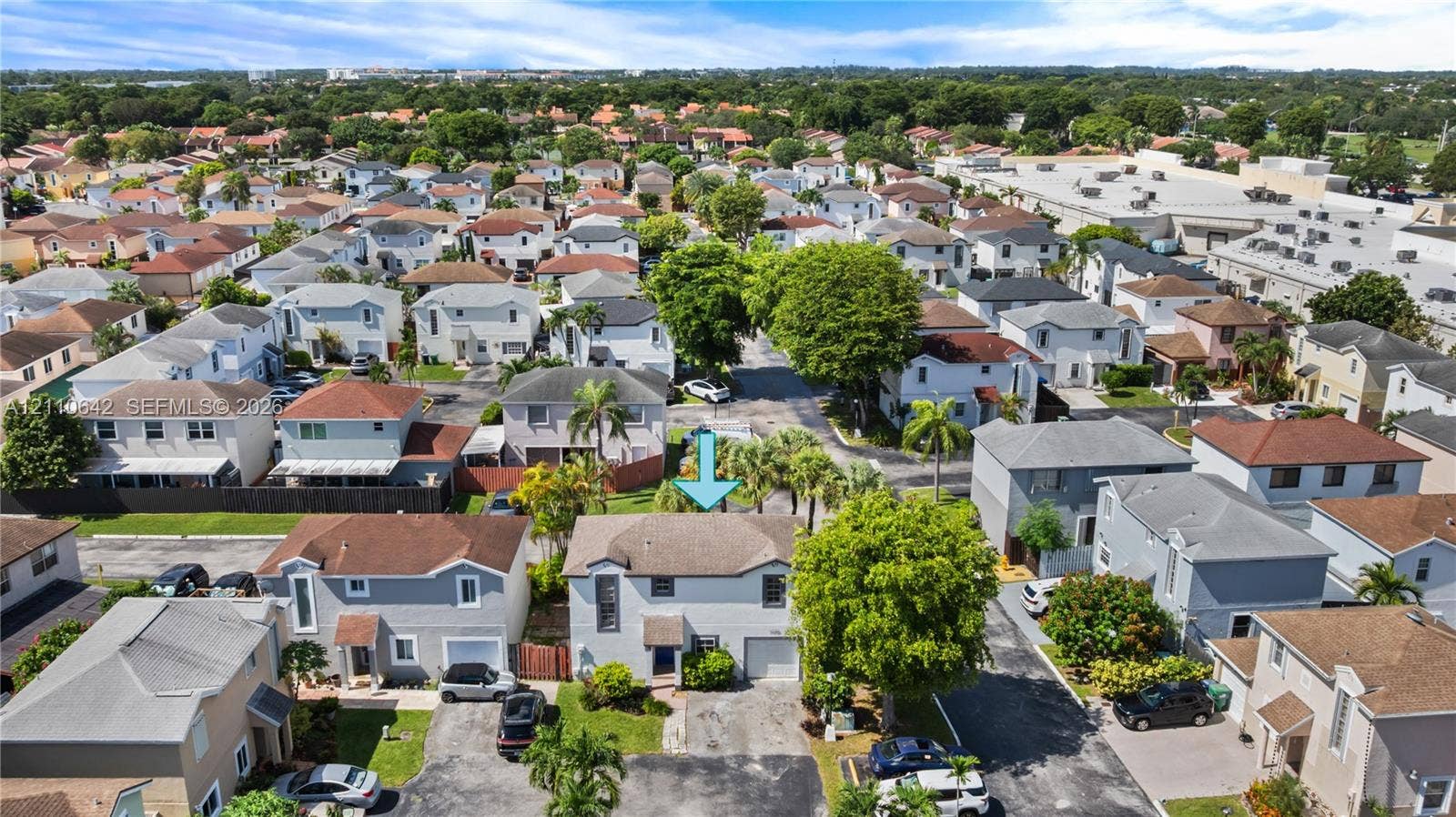 14732 SW 90th Terrace, Miami, FL 33196 Two-story residence featuring a shingled roof, light-toned siding, integrated single-car garage, and established landscaping