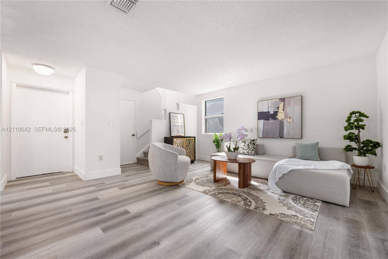 14732 SW 90th Terrace, Miami, FL 33196 Neutral interior featuring light-toned wood-finish flooring, crisp white wall finishes, and a single-pane window