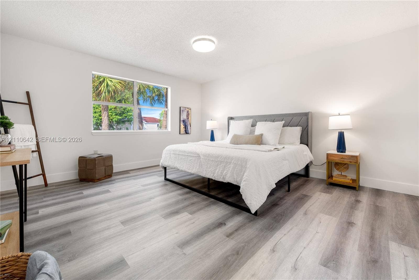 14732 SW 90th Terrace, Miami, FL 33196 Neutral-toned interior space featuring wood-finish flooring, a large window, and a flush-mount ceiling fixture