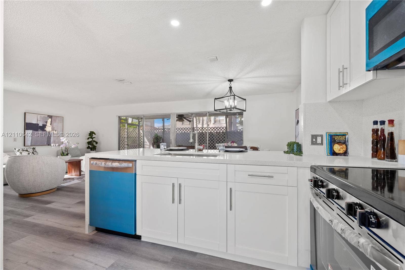 14732 SW 90th Terrace, Miami, FL 33196 Kitchen featuring white cabinetry, quartz countertops, a stainless steel undermount sink, and wood-finish flooring