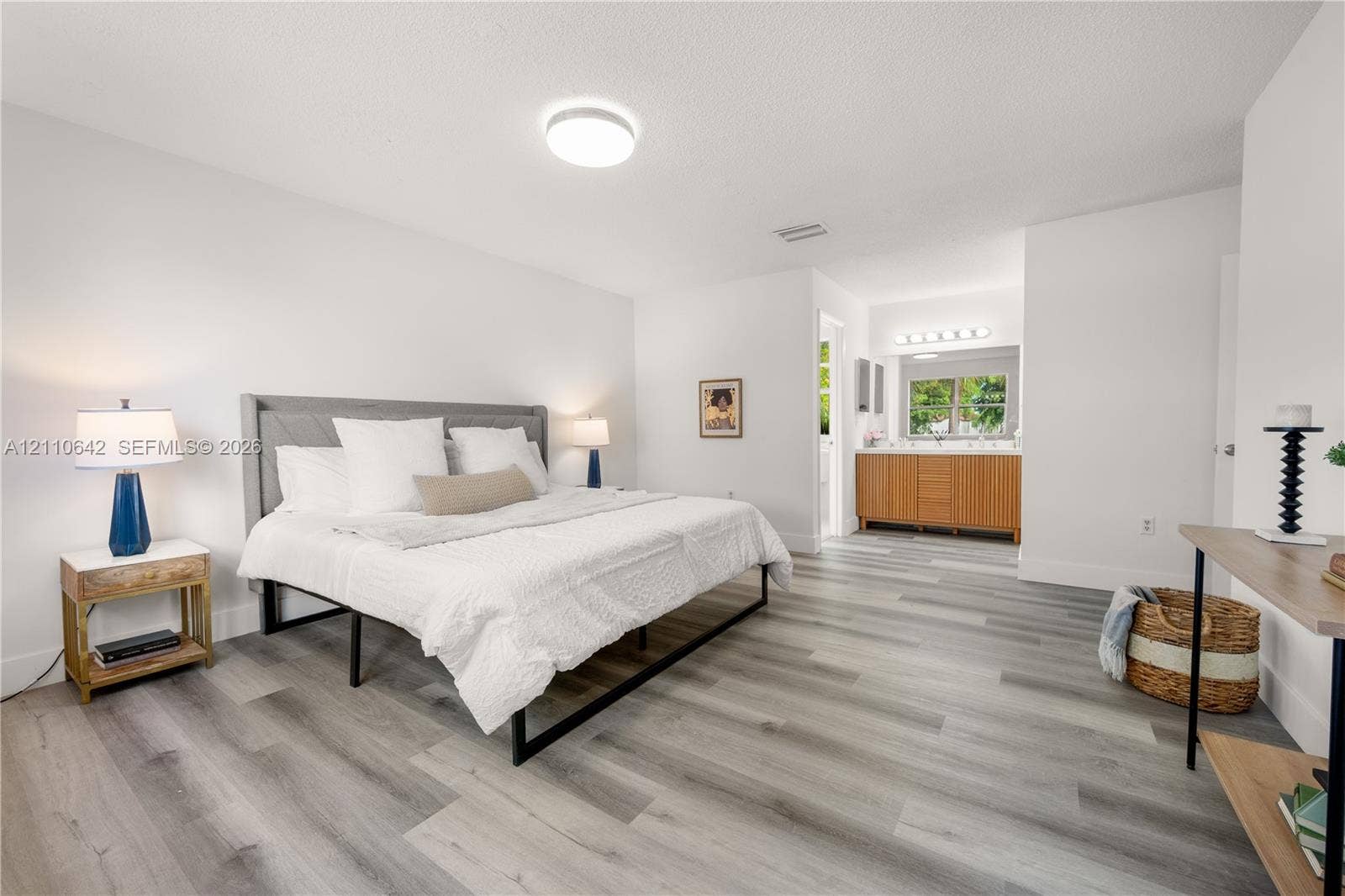 14732 SW 90th Terrace, Miami, FL 33196 Neutral-toned wood-finish flooring and integrated vanity with wooden cabinetry