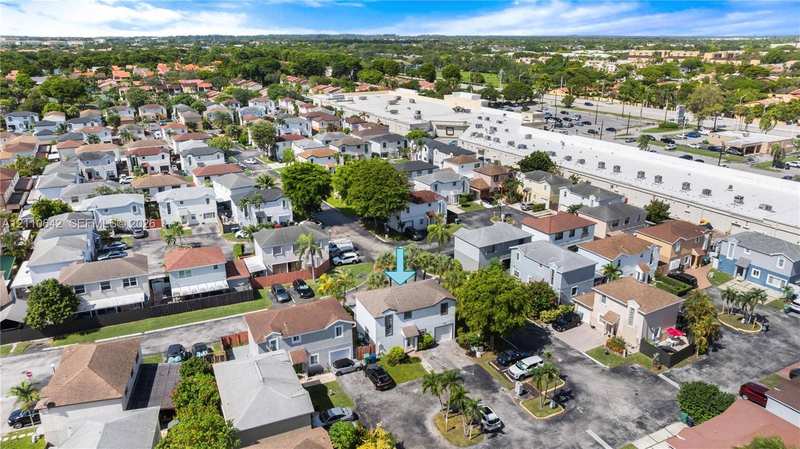 14732 SW 90th Terrace, Miami, FL 33196 Aerial perspective of a two-story residence featuring a shingled roof, stucco exterior, attached garage, and paved driveway