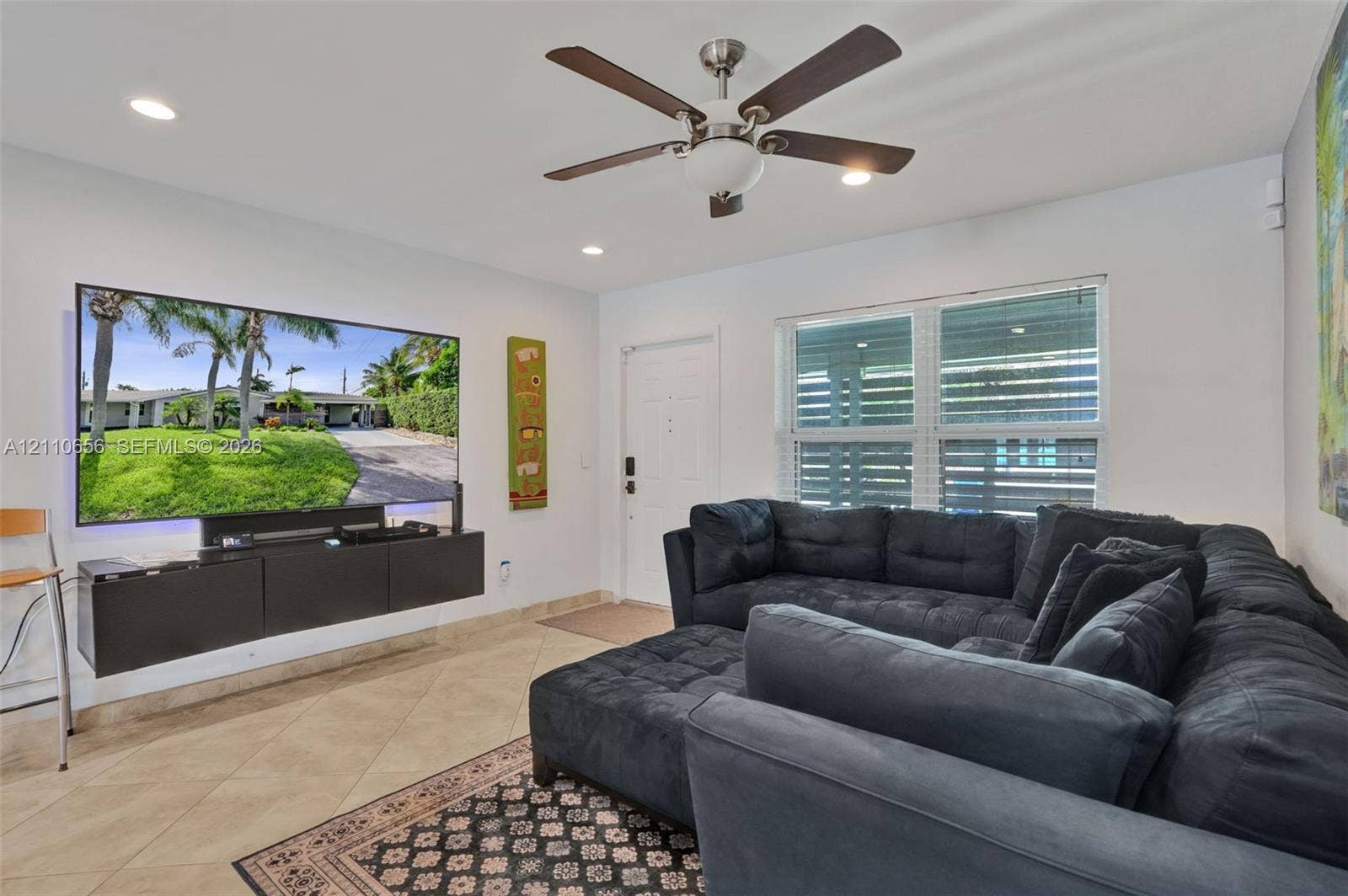 30 NE 48th Court, Oakland Park, FL 33334 Ceramic tile flooring, recessed lighting, ceiling fan with light fixture, and wall-mounted storage cabinetry