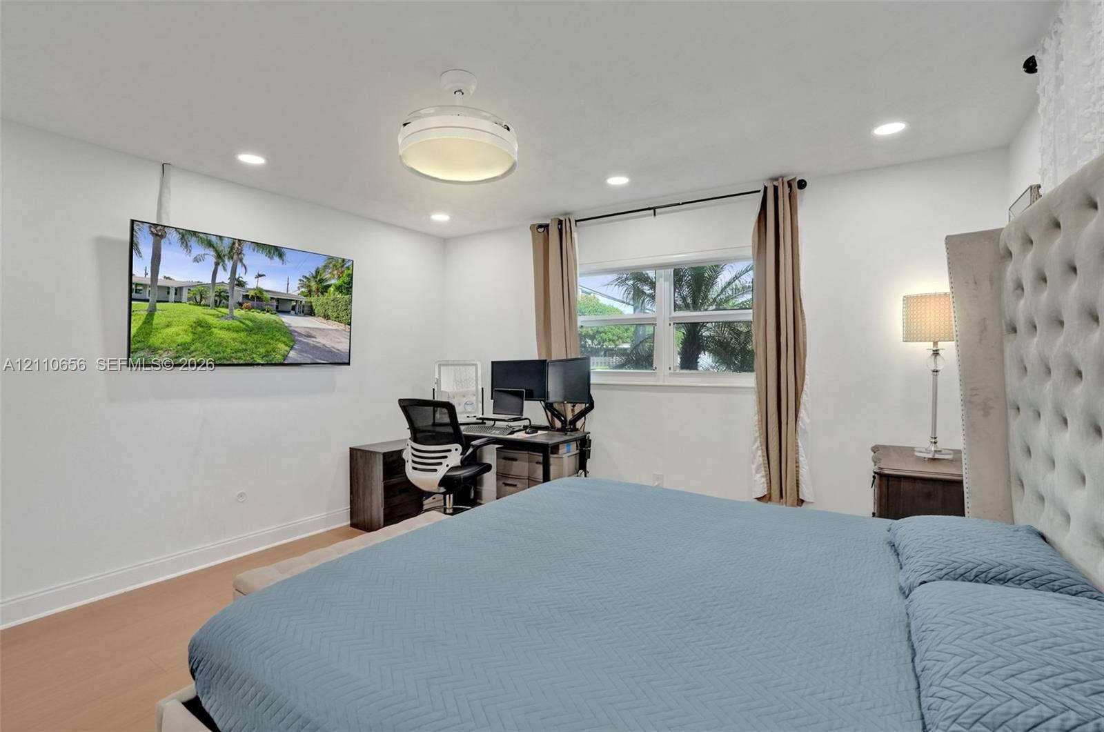 30 NE 48th Court, Oakland Park, FL 33334 Wood-finish flooring, recessed lighting, ceiling-mounted light fixture, and horizontal sliding window