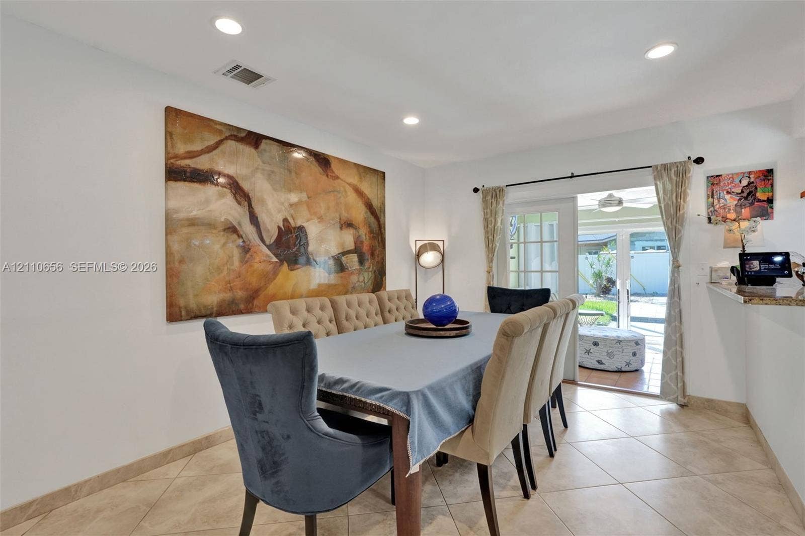 30 NE 48th Court, Oakland Park, FL 33334 Neutral tile flooring, recessed lighting, and a glass-paneled sliding door providing exterior access