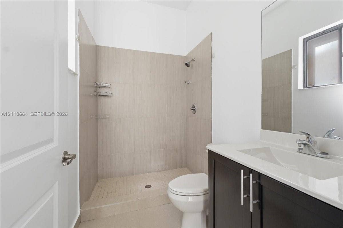 Versatile first-floor bedroom with a private full bathroom, ideal for guests or a home office.