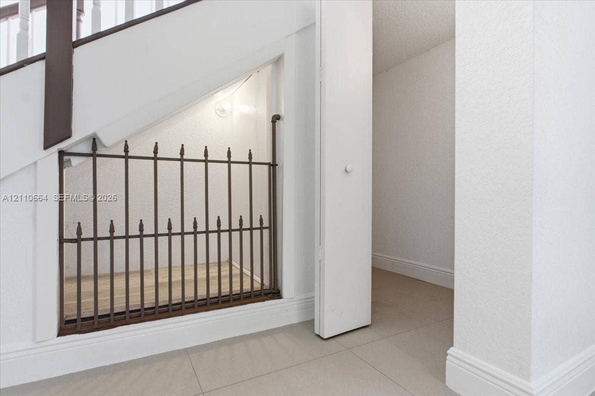 Thoughtful under-stair pet nook complemented by additional storage space