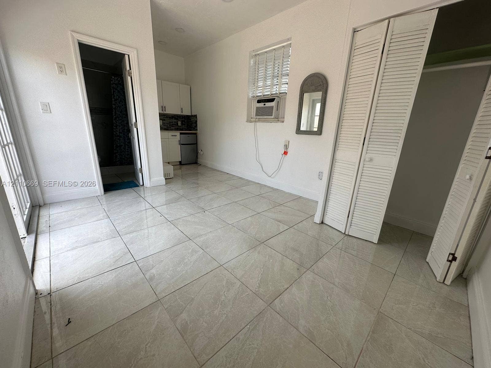 1635 Hollywood Boulevard, #B, Hollywood, Hollywood, FL 33020 Neutral tile flooring, white cabinetry, louvered closet doors, and recessed ceiling lighting