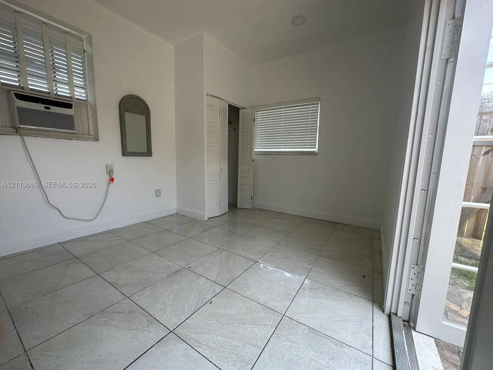 1635 Hollywood Boulevard, #B, Hollywood, Hollywood, FL 33020 Neutral-toned tile flooring, louvered closet doors, and windows equipped with adjustable horizontal blinds