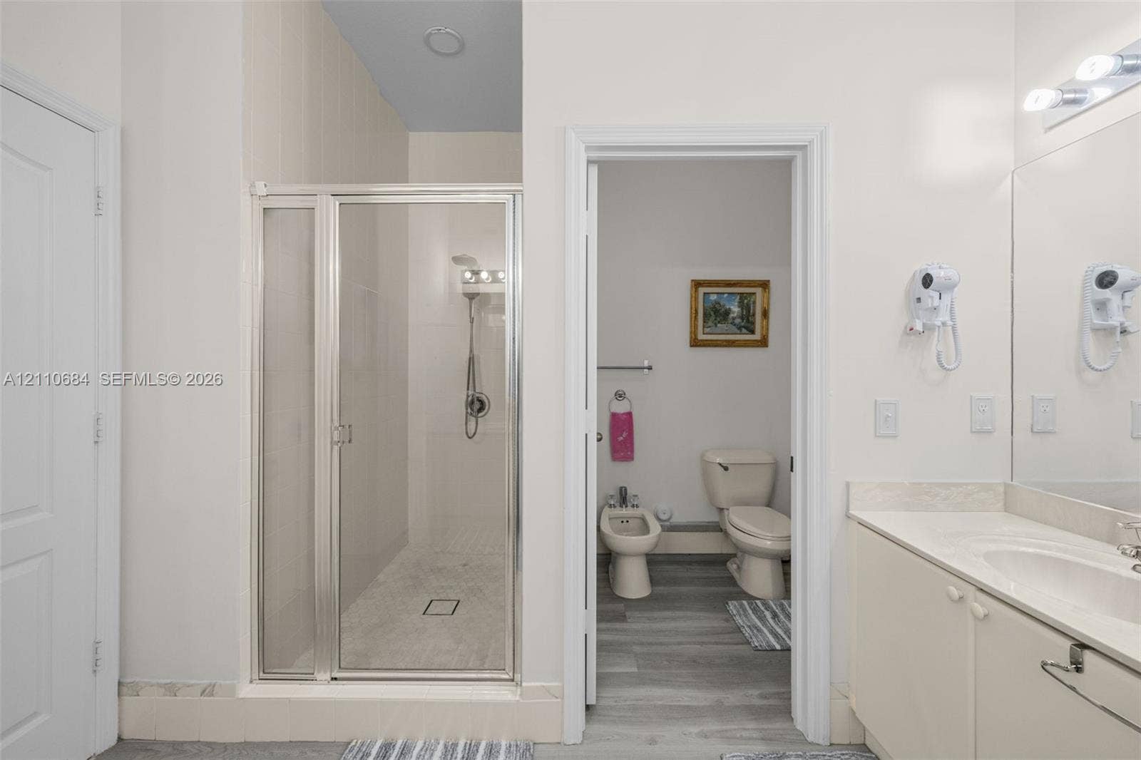 13542 SW 177th Terrace, Miami, FL 33177 walk-in shower with metal-framed glass enclosure, vanity with integrated basin, bidet, toilet