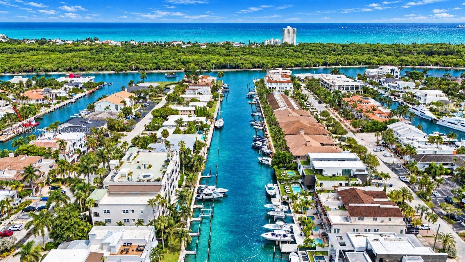 Waterfront community featuring pristine canals with private boat docking, lush tropical landscaping throughout the neighborhood, Mediterranean and contemporary architectural styles, and direct water access to navigable waterways
