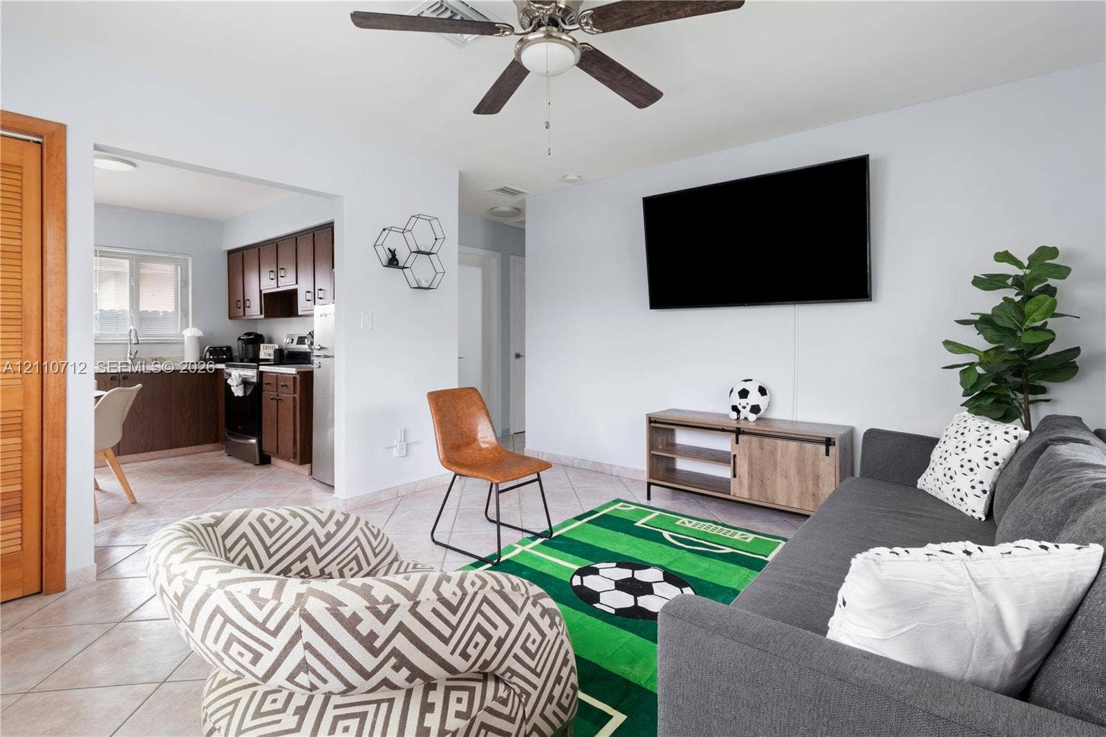 Interior space featuring neutral wall tones, ceramic tile flooring, and a ceiling fan