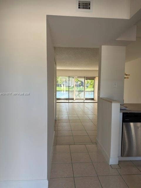 2297 SW 15th Street, #125, Deerfield Beach, Deerfield Beach, FL 33442 Large ceramic tile flooring, stainless steel dishwasher, and expansive sliding glass doors