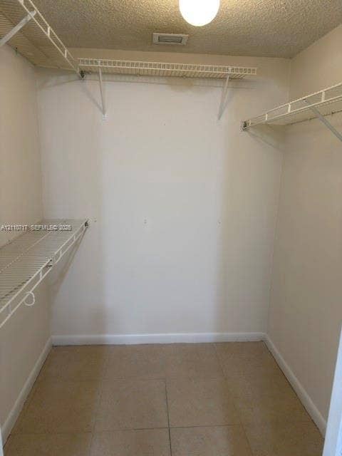 2297 SW 15th Street, #125, Deerfield Beach, Deerfield Beach, FL 33442 Walk-in closet featuring tiled flooring and tiered white wire shelving