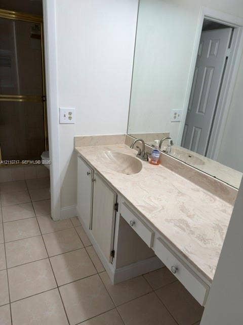 2297 SW 15th Street, #125, Deerfield Beach, Deerfield Beach, FL 33442 Vanity featuring a light-toned solid surface countertop with an integrated oval sink, full-width wall mirror, lower cabinetry, and ceramic tile flooring