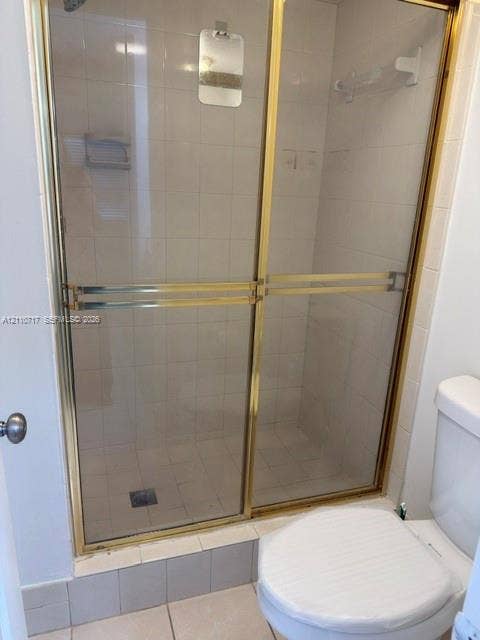 2297 SW 15th Street, #125, Deerfield Beach, Deerfield Beach, FL 33442 Shower stall featuring sliding glass doors with gold-toned metal framing and interior wall tiling