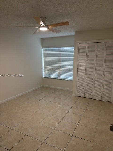 2297 SW 15th Street, #125, Deerfield Beach, Deerfield Beach, FL 33442 Ceramic tile flooring, white louvered-style closet doors, ceiling fan with integrated lighting, and horizontal window blinds