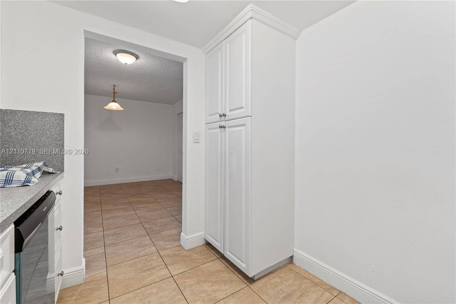 9375 Fontainebleau Boulevard, #L314, Miami, FL 33172 Floor-to-ceiling built-in white cabinetry, stone-finish countertops, and ceramic tile flooring