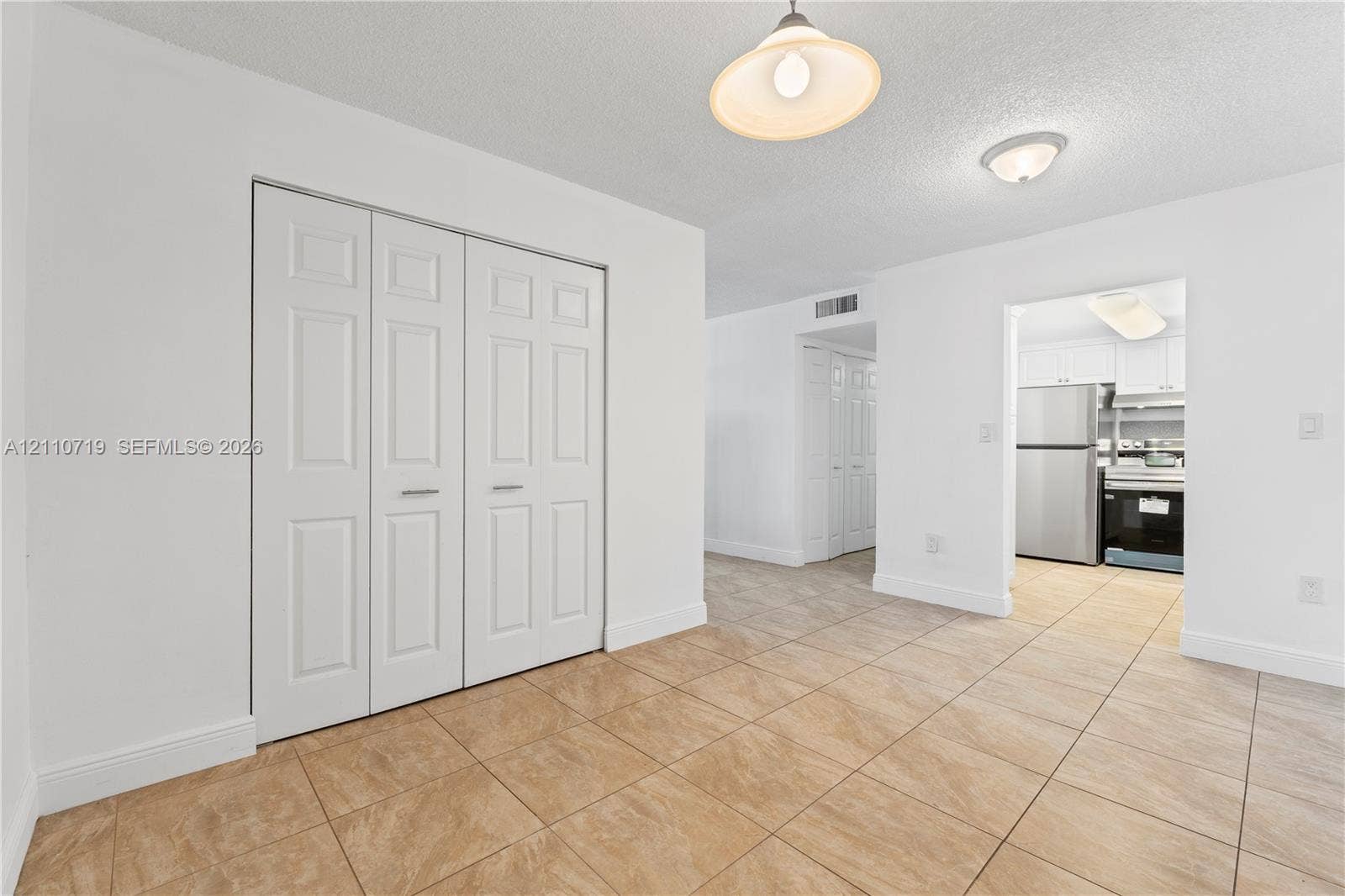 9375 Fontainebleau Boulevard, #L314, Miami, FL 33172 Ceramic tile flooring, white bi-fold closet doors, and recessed ceiling lighting