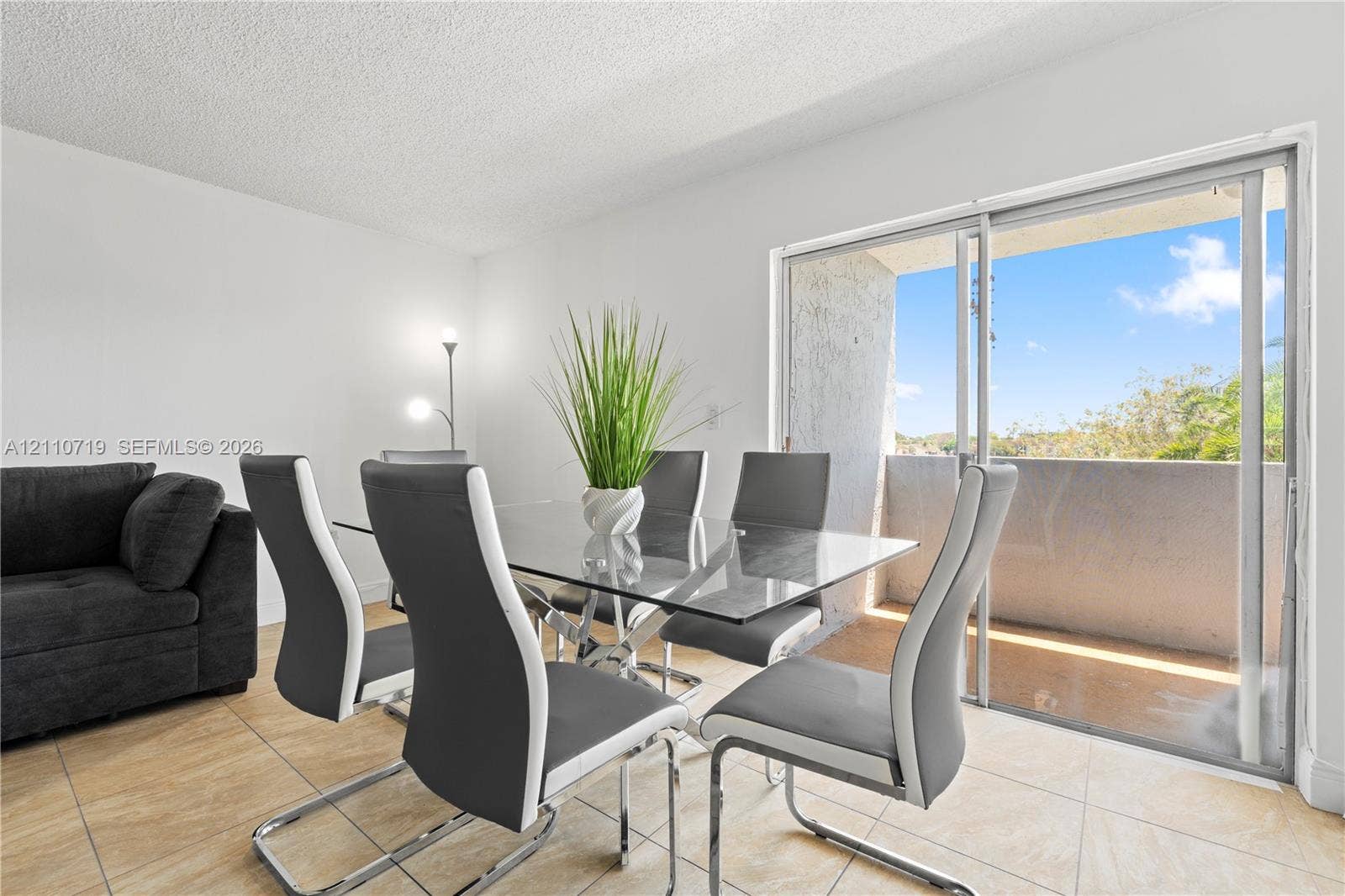 9375 Fontainebleau Boulevard, #L314, Miami, FL 33172 Ceramic tile flooring, sliding glass door, and private exterior balcony