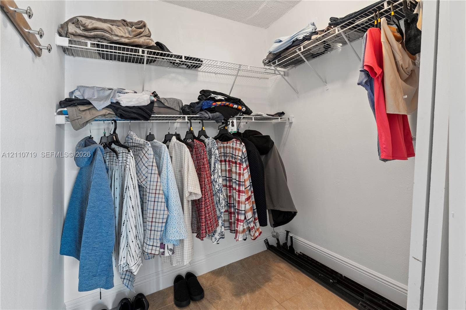 9375 Fontainebleau Boulevard, #L314, Miami, FL 33172 Walk-in closet featuring multi-level wire shelving systems and neutral floor tile