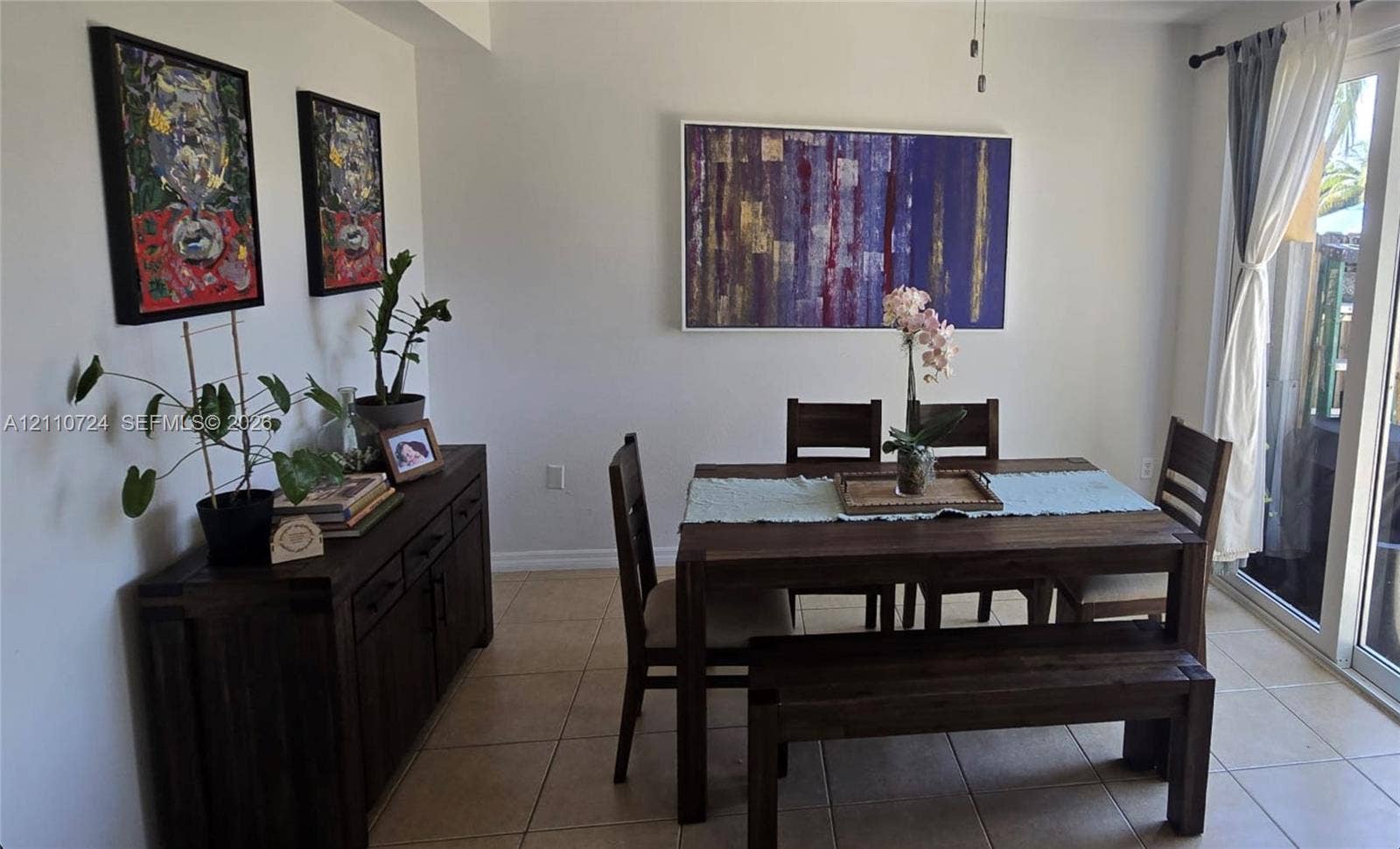 10846 SW 240th Lane, Homestead, FL 33032 Neutral-toned interior featuring ceramic tile flooring and a sliding glass door providing natural light