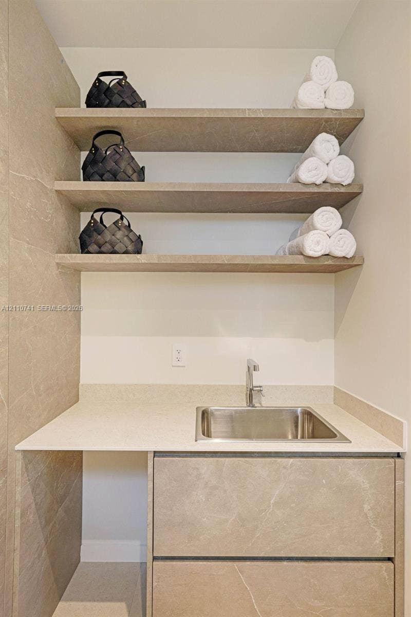 9445 SW 73rd Avenue, Pinecrest, FL 33156 laundry room with built in cabinetry