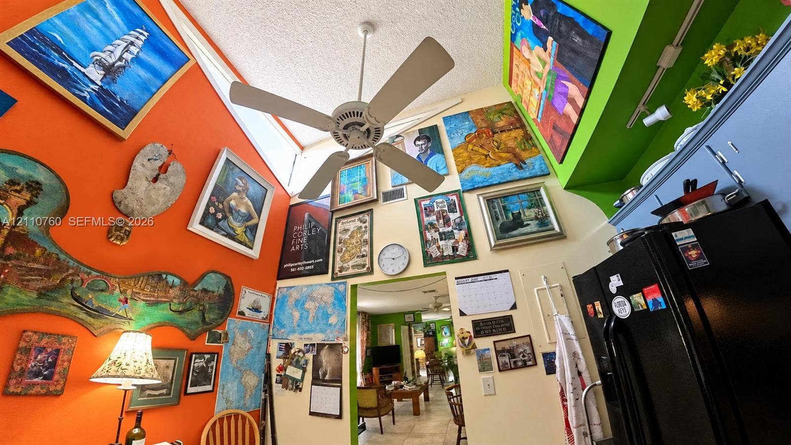 Vaulted ceilings featuring a central white ceiling fan