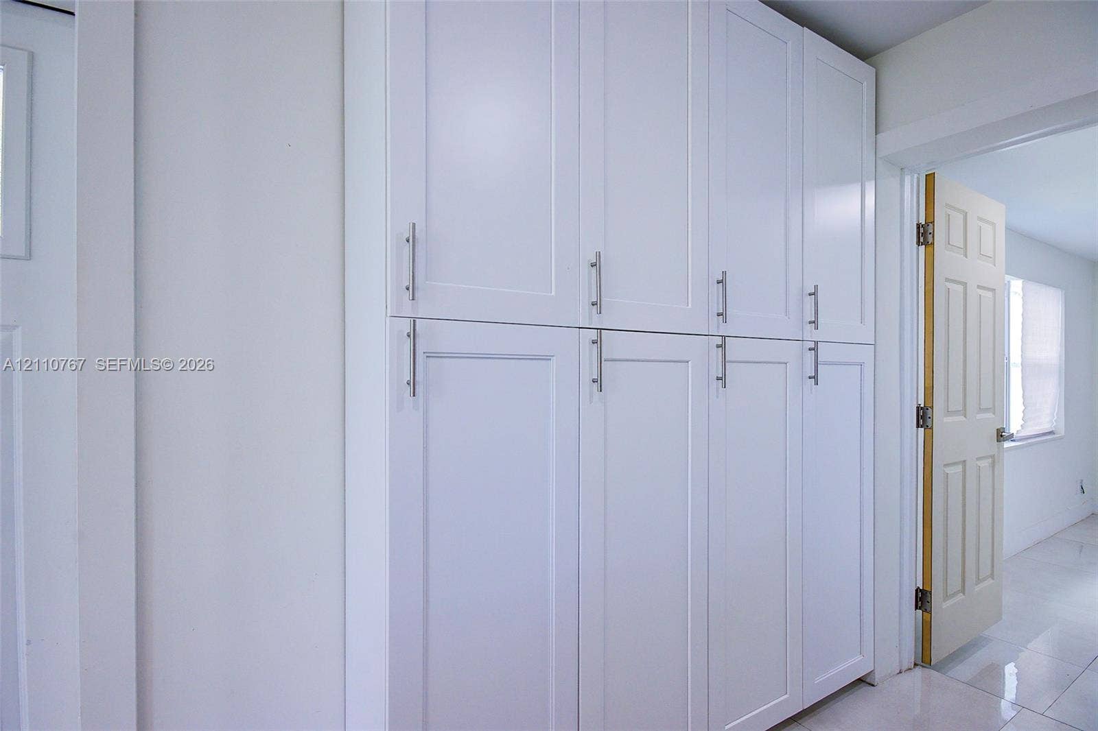 5305 Cleveland Road, Delray Beach, FL 33484 Built-in floor-to-ceiling cabinetry featuring white Shaker-style doors and metallic bar pulls