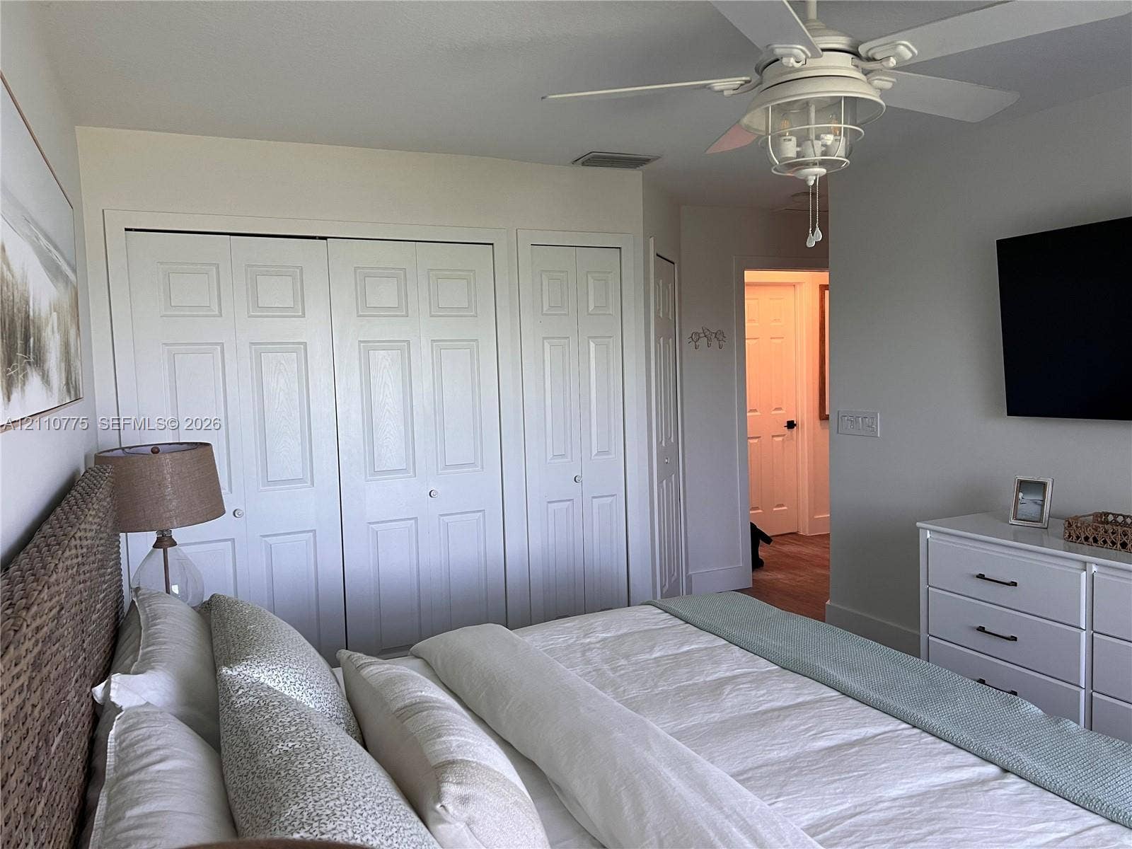 4995 S Highway A1a, #D, Melbourne Beach, FL 32951 Primary bedroom featuring paneled bi-fold closet doors and a ceiling-mounted fan with integrated light fixture