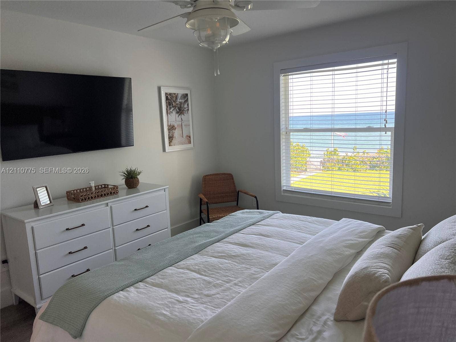 4995 S Highway A1a, #D, Melbourne Beach, FL 32951 Room featuring neutral wall paint, ceiling fan with integrated lighting, and a double-hung window with horizontal blinds