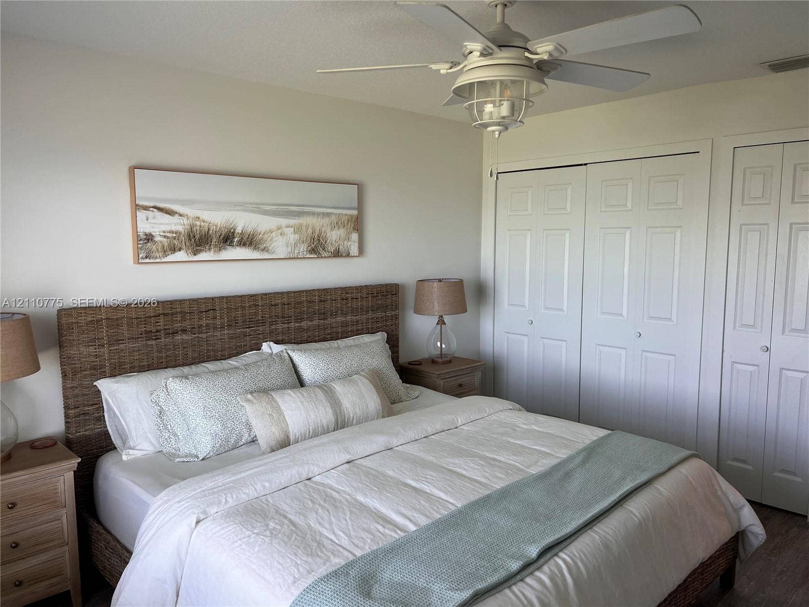 4995 S Highway A1a, #D, Melbourne Beach, FL 32951 Ceiling-mounted light fixture with an integrated fan and dual-panel closet doors