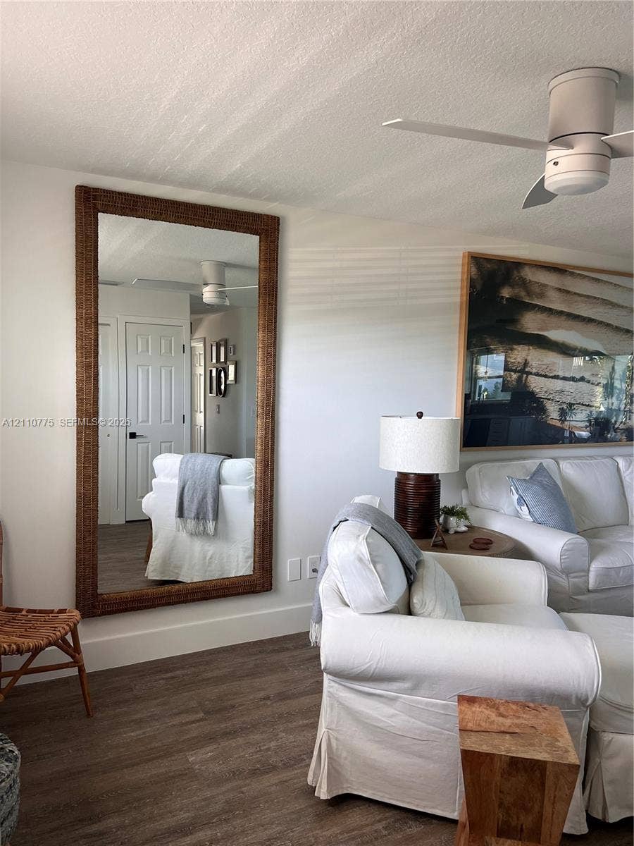 4995 S Highway A1a, #D, Melbourne Beach, FL 32951 Wood-finish flooring, white paneled interior doors, and modern low-profile ceiling fan