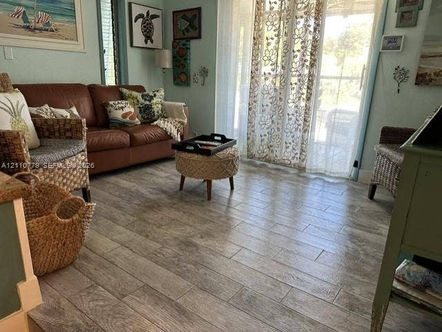 Wood-finish tile flooring and sliding glass doors with exterior access