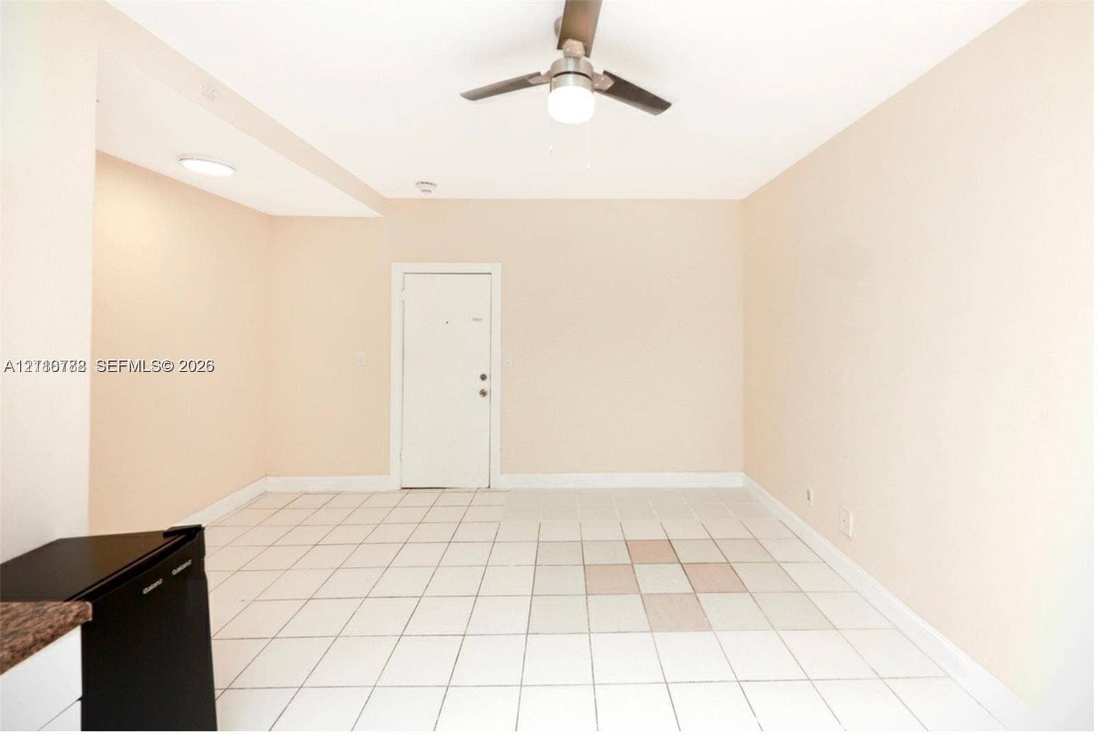 3710 Collins Avenue, #N-202, Miami Beach, FL 33140 Neutral-toned interior featuring ceramic tile flooring, a central ceiling fan with an integrated light fixture, and recessed overhead lighting