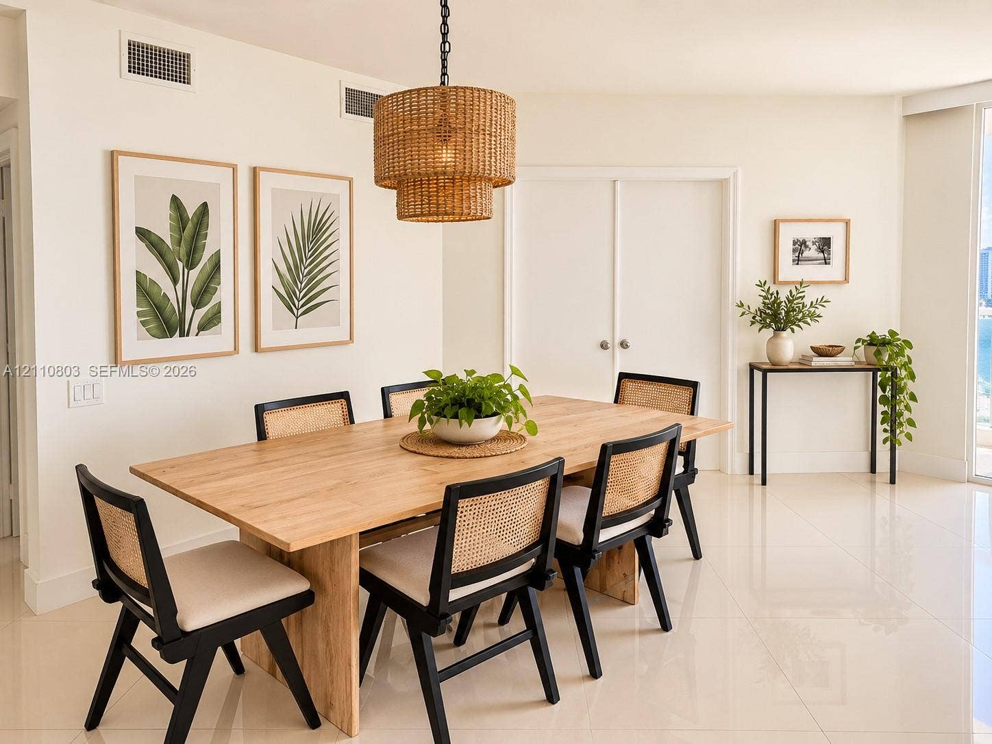 Dining area featuring polished large-format tile flooring and a multi-tiered woven pendant light fixture
