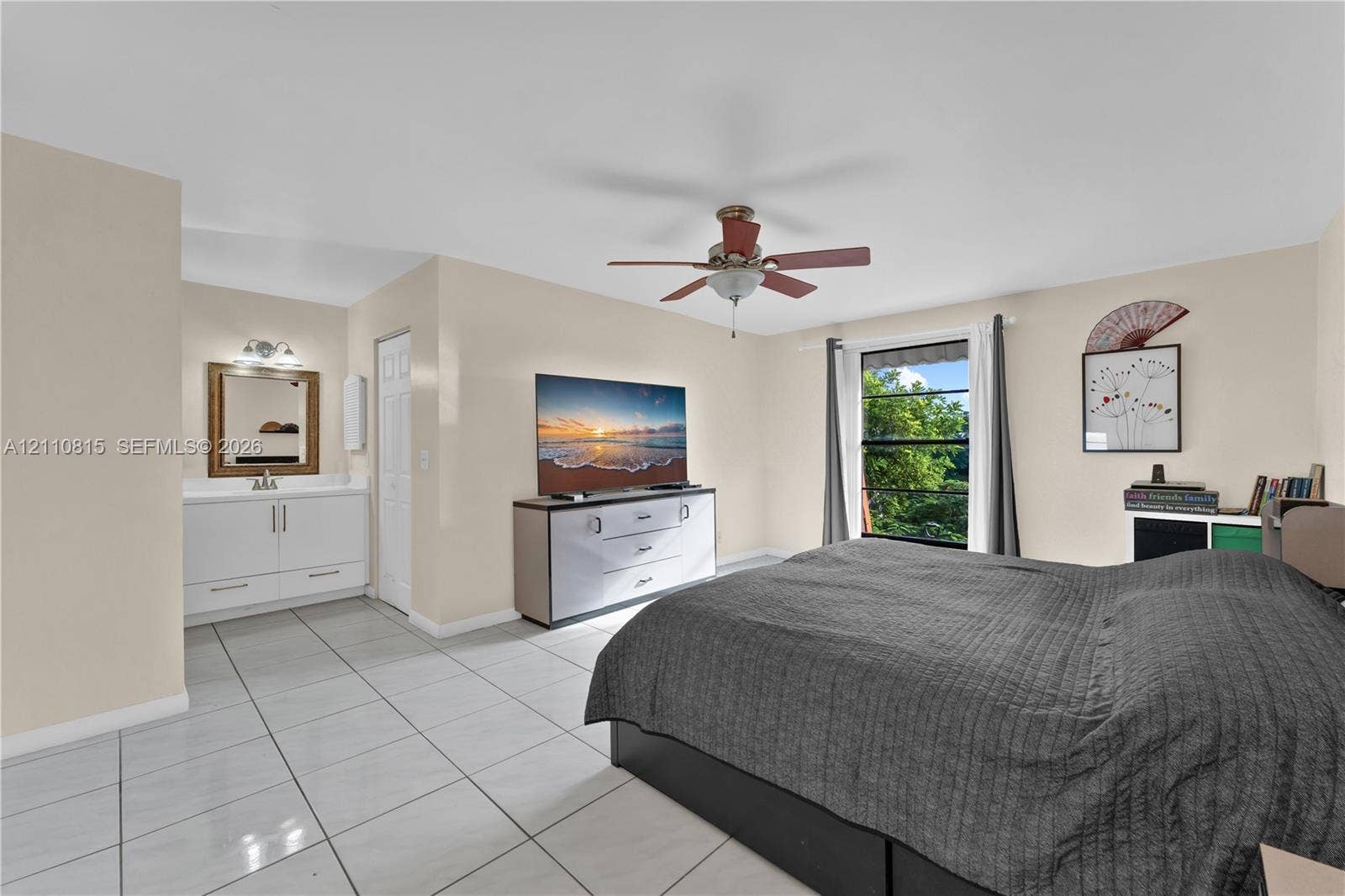 9100 Orchid Tree Lane, #137, Pembroke Pines, FL 33024 Room featuring tile flooring, a built-in vanity with a framed mirror, and a ceiling fan with integrated lighting