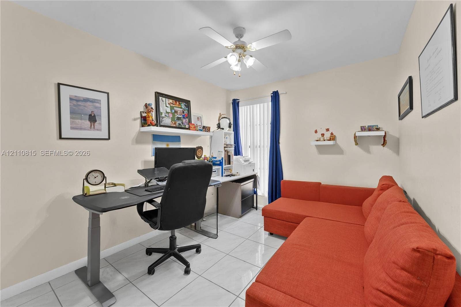 9100 Orchid Tree Lane, #137, Pembroke Pines, FL 33024 Room featuring large-format ceramic tile flooring, a central ceiling fan with integrated lighting, and a vertical window with neutral walls