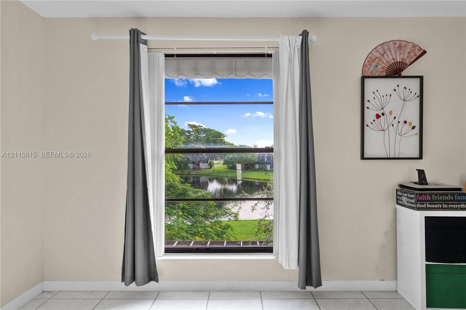 9100 Orchid Tree Lane, #137, Pembroke Pines, FL 33024 Single-pane window featuring a landscape exposure of a water feature and surrounding foliage