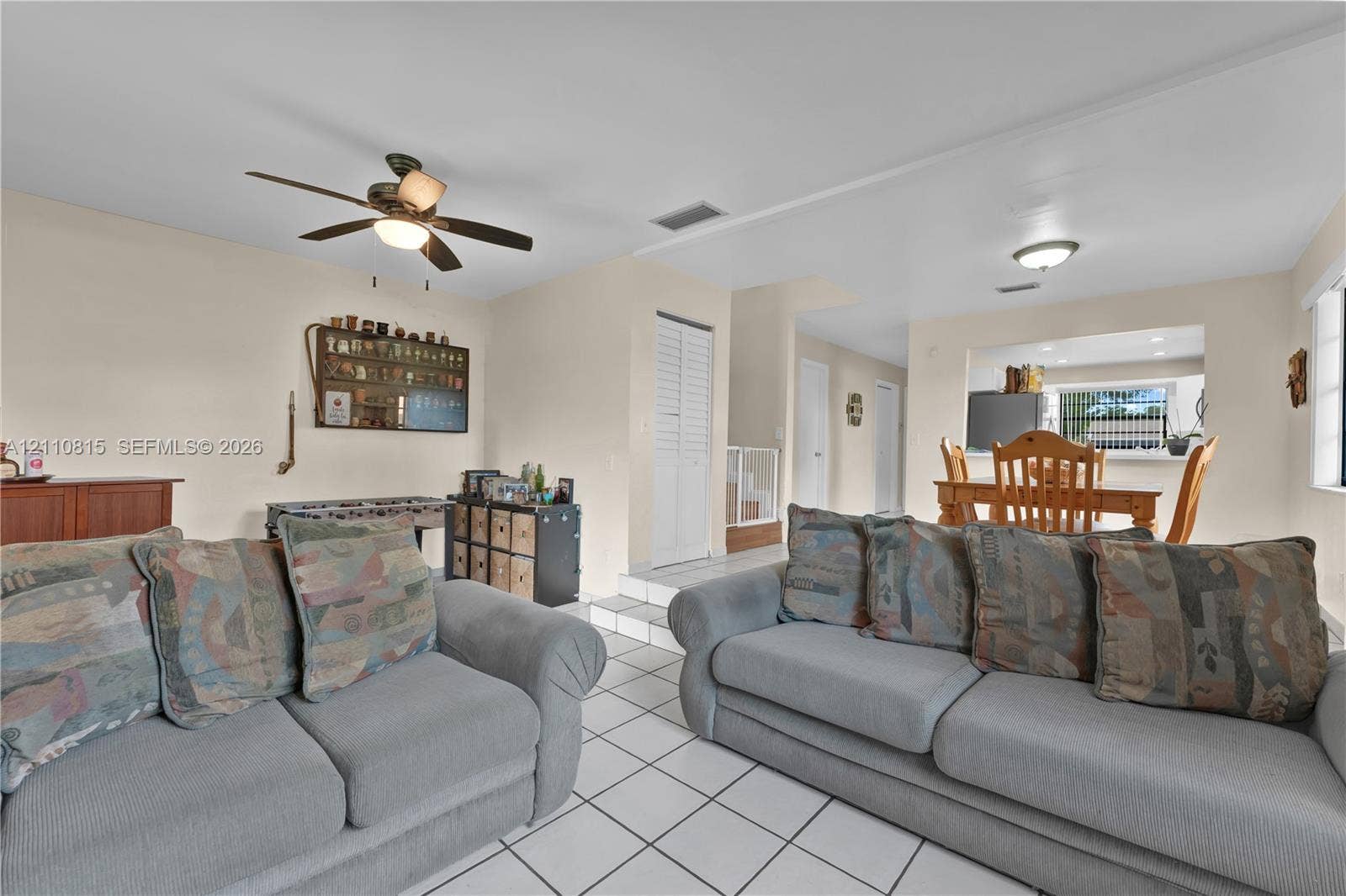 9100 Orchid Tree Lane, #137, Pembroke Pines, FL 33024 Living area featuring light-toned tile flooring, recessed lighting, a ceiling fan, and a pass-through opening to a dining space