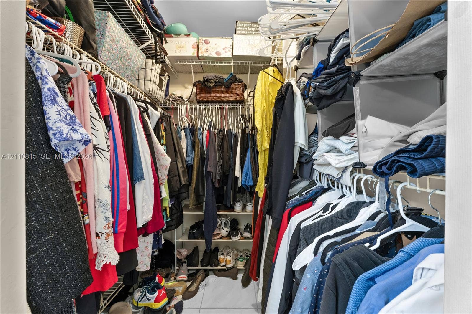9100 Orchid Tree Lane, #137, Pembroke Pines, FL 33024 Walk-in closet featuring multi-level white wire shelving and integrated vertical storage compartments